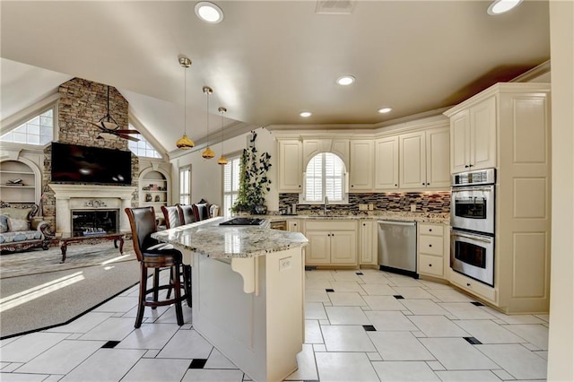 8455 Abingdon Ln, Duluth, GA 30097 - kitchen featuring appliances with stainless steel finishes, open floor plan, a peninsula, a breakfast bar area, and light stone countertops