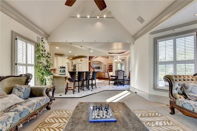 8455 Abingdon Ln, Duluth, GA 30097 - living area with light carpet, ceiling fan, lofted ceiling, arched walkways, and a chandelier