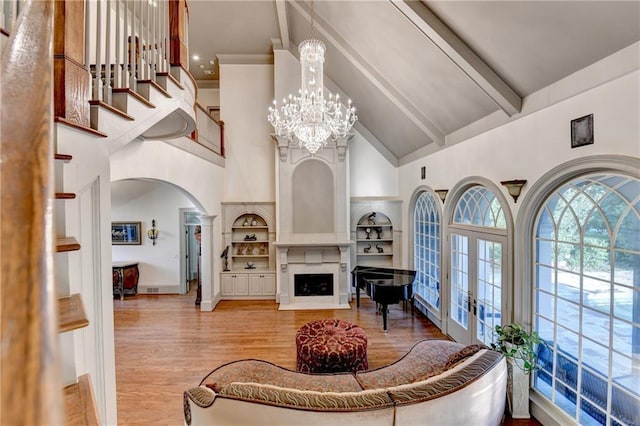 8455 Abingdon Ln, Duluth, GA 30097 - living room with high vaulted ceiling, arched walkways, wood finished floors, beam ceiling, and built in features
