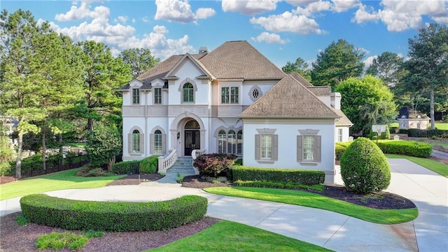 8455 Abingdon Ln, Duluth, GA 30097 - french country style house with a chimney and stucco siding
