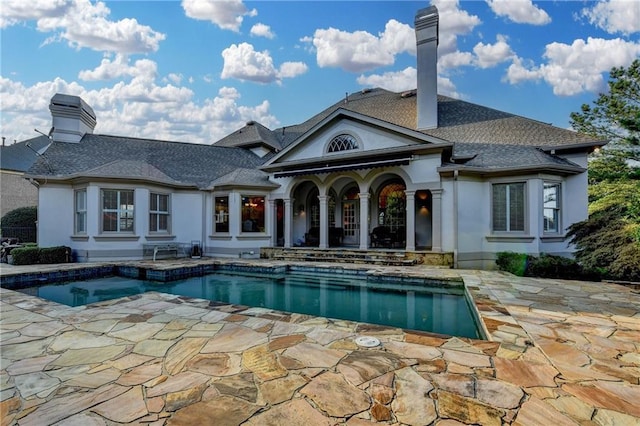8455 Abingdon Ln, Duluth, GA 30097 - back of property with a patio, an outdoor pool, a chimney, and stucco siding