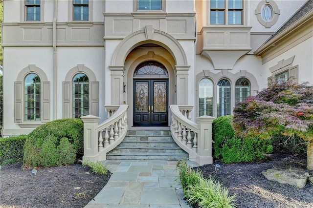 8455 Abingdon Ln, Duluth, GA 30097 - view of exterior entry with stucco siding and french doors