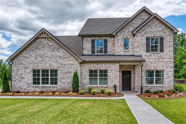 700 Relic Rdg, Hampton, GA 30228 - craftsman house featuring a front yard, a shingled roof, and brick siding