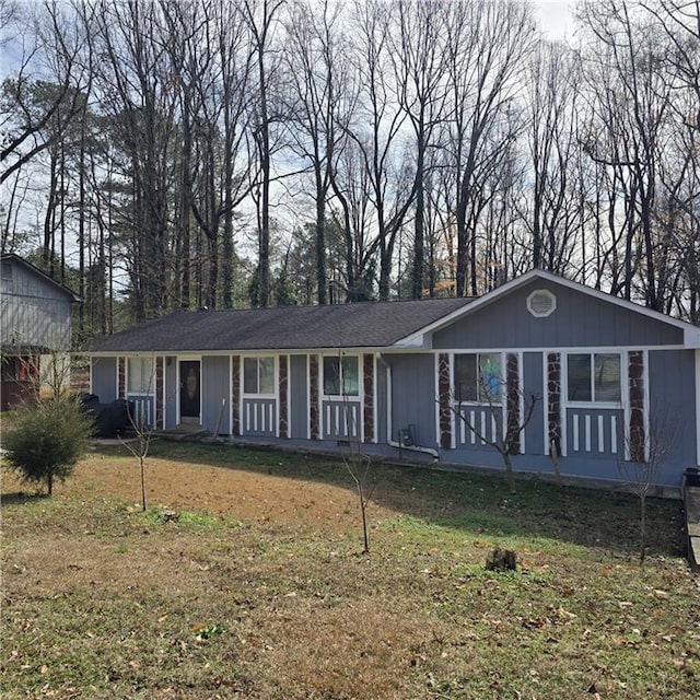 single story home featuring a porch, board and batten siding, and a front lawn