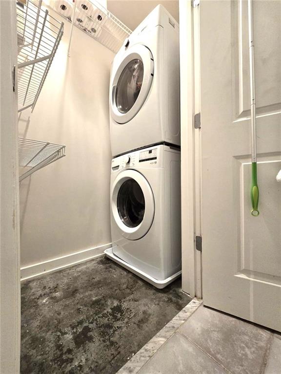 laundry room with stacked washer / drying machine