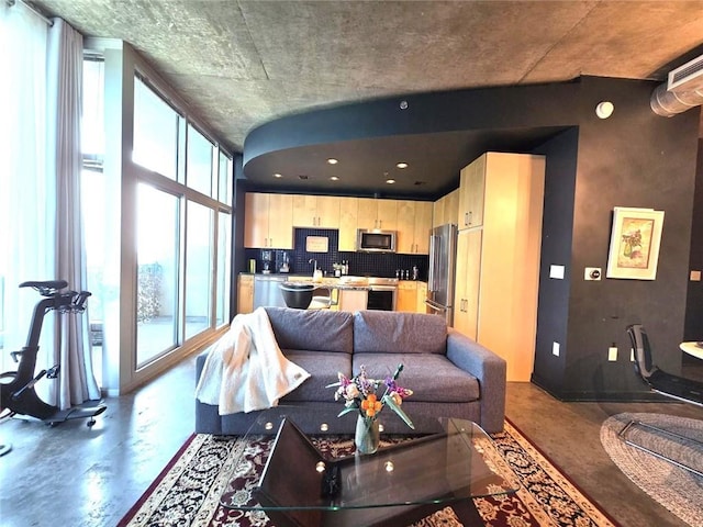 living room with plenty of natural light and concrete flooring