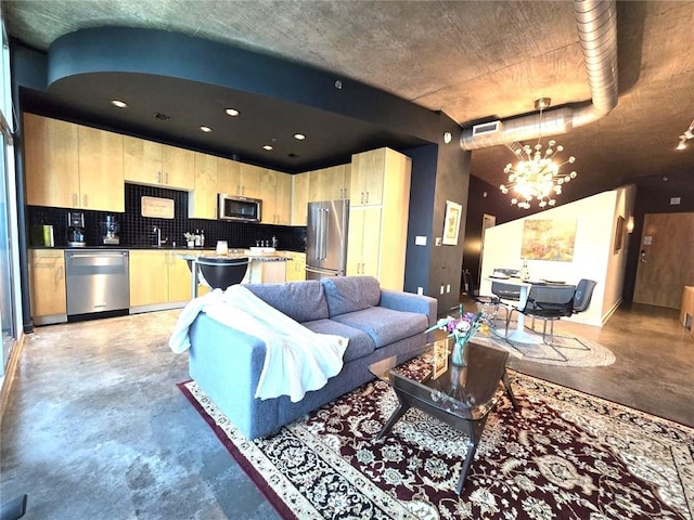 living room with an inviting chandelier and sink