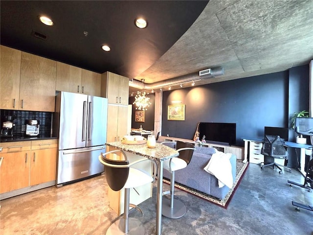 interior space featuring rail lighting and an inviting chandelier