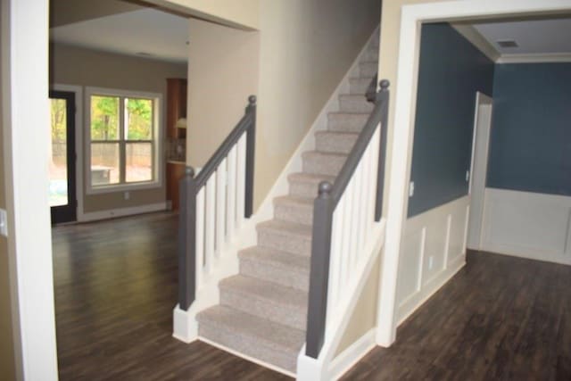 stairs featuring hardwood / wood-style floors