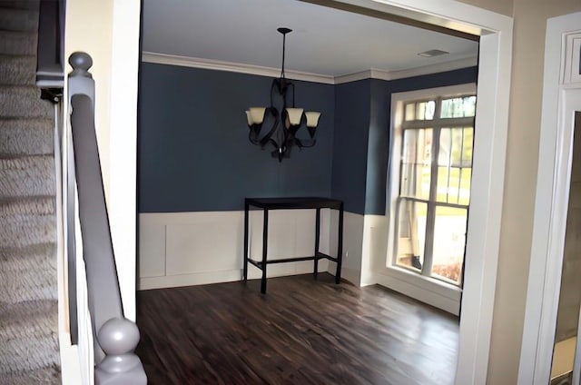 unfurnished dining area featuring ornamental molding, a notable chandelier, and dark hardwood / wood-style floors