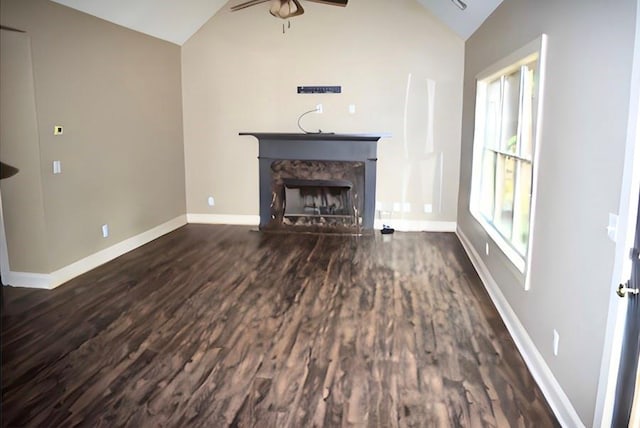 unfurnished living room with ceiling fan, lofted ceiling, a high end fireplace, and dark hardwood / wood-style floors