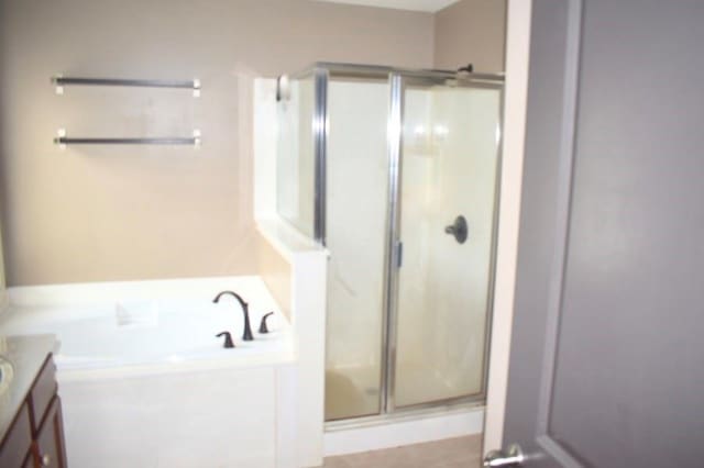 bathroom featuring vanity and plus walk in shower