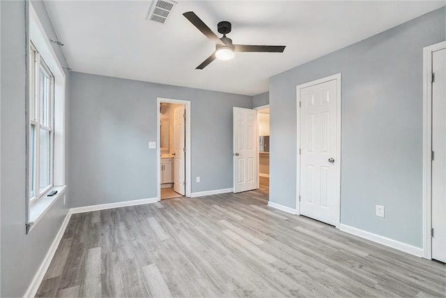 unfurnished bedroom featuring ceiling fan, light hardwood / wood-style floors, and connected bathroom