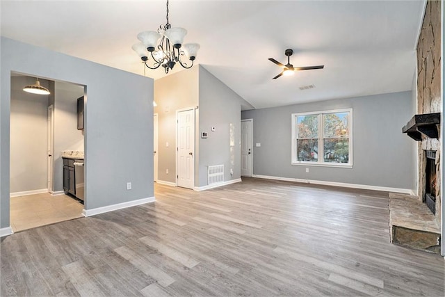 unfurnished living room with a fireplace, ceiling fan with notable chandelier, light hardwood / wood-style flooring, and vaulted ceiling