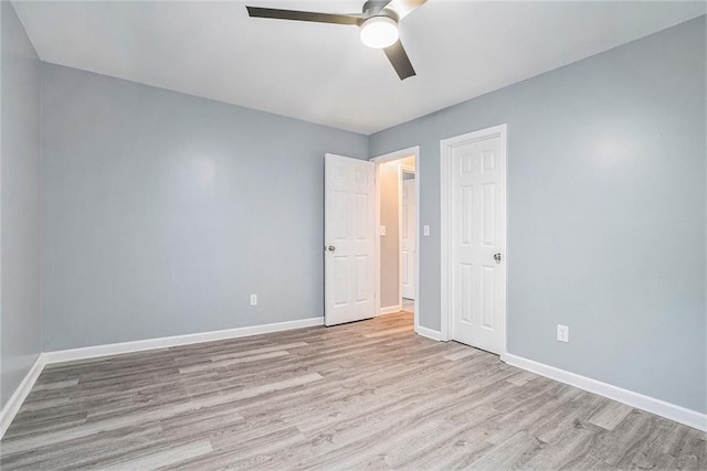 unfurnished bedroom with a closet, light hardwood / wood-style flooring, and ceiling fan