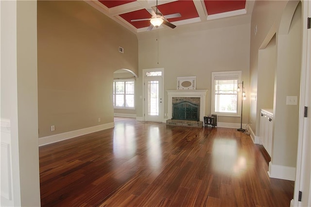 1520 Camden Cove Dr, Cumming, GA 30040 - unfurnished living room featuring a high ceiling, a ceiling fan, coffered ceiling, baseboards, and arched walkways