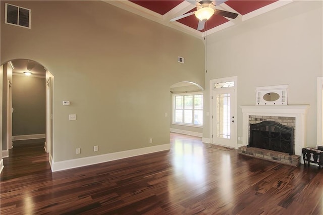 1520 Camden Cove Dr, Cumming, GA 30040 - unfurnished living room with a ceiling fan, arched walkways, coffered ceiling, baseboards, and a high ceiling