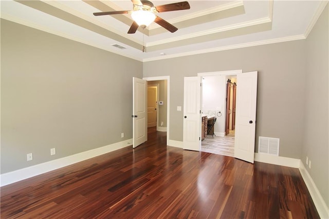 1520 Camden Cove Dr, Cumming, GA 30040 - unfurnished bedroom featuring a tray ceiling, dark wood finished floors, crown molding, baseboards, and a ceiling fan