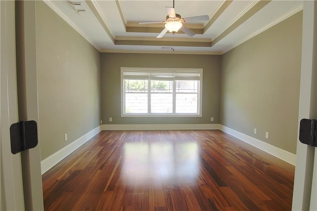 1520 Camden Cove Dr, Cumming, GA 30040 - spare room featuring a tray ceiling, dark wood-style flooring, a ceiling fan, crown molding, and baseboards