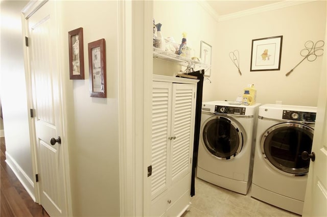 1520 Camden Cove Dr, Cumming, GA 30040 - clothes washing area featuring washer and dryer, crown molding, and tile patterned flooring