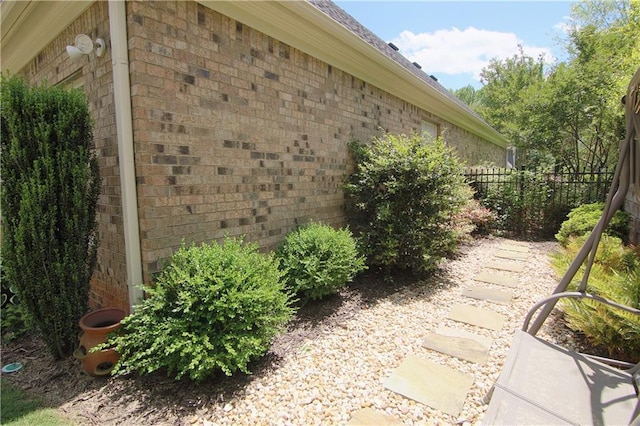 1520 Camden Cove Dr, Cumming, GA 30040 - view of side of home with brick siding, fence, and a shingled roof
