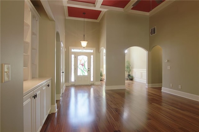1520 Camden Cove Dr, Cumming, GA 30040 - foyer featuring arched walkways, a high ceiling, dark wood finished floors, coffered ceiling, and ornamental molding