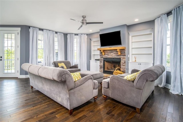 living room featuring a ceiling fan, dark wood finished floors, recessed lighting, a fireplace, and baseboards