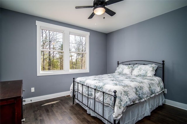 bedroom featuring ceiling fan, baseboards, and dark wood-style flooring