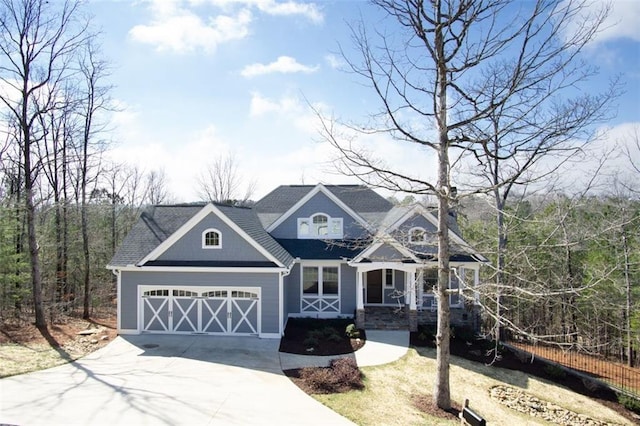 craftsman house featuring covered porch, concrete driveway, and a garage