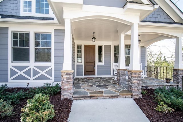 view of exterior entry with a porch