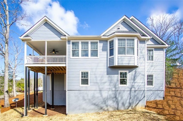 back of house featuring a carport and ceiling fan