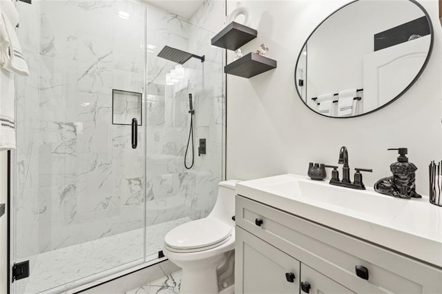 bathroom with a shower with door, vanity, and toilet