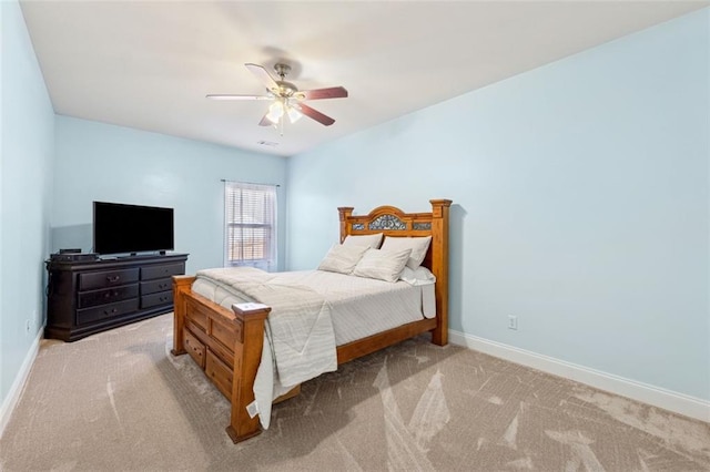 bedroom with ceiling fan and light carpet