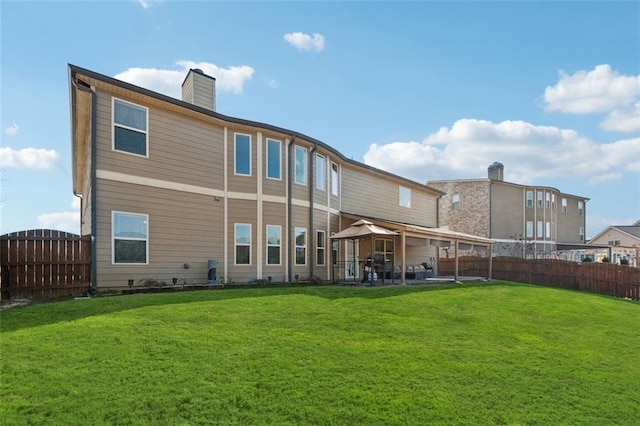 back of property with a patio and a lawn