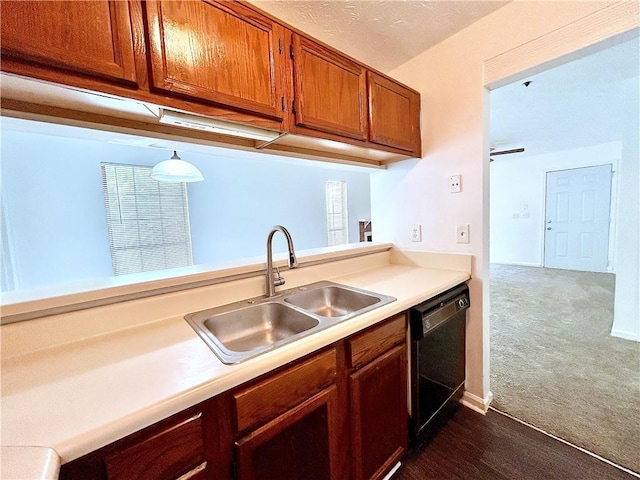 kitchen featuring dark colored carpet, dishwasher, and sink