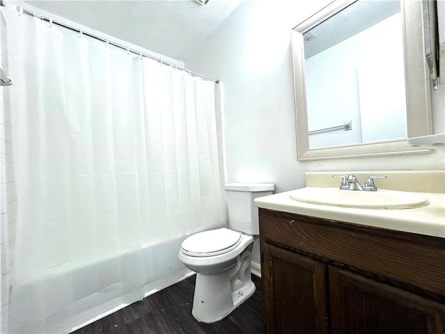 full bathroom with vanity, wood-type flooring, toilet, and shower / tub combo with curtain