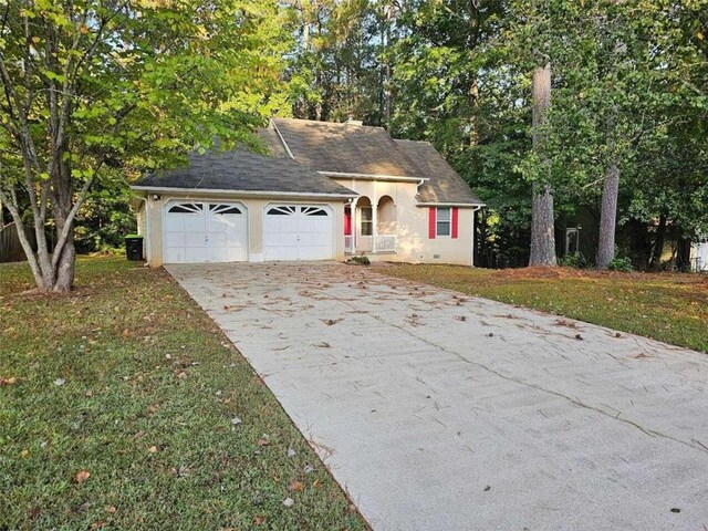 view of front facade with a front yard and a garage