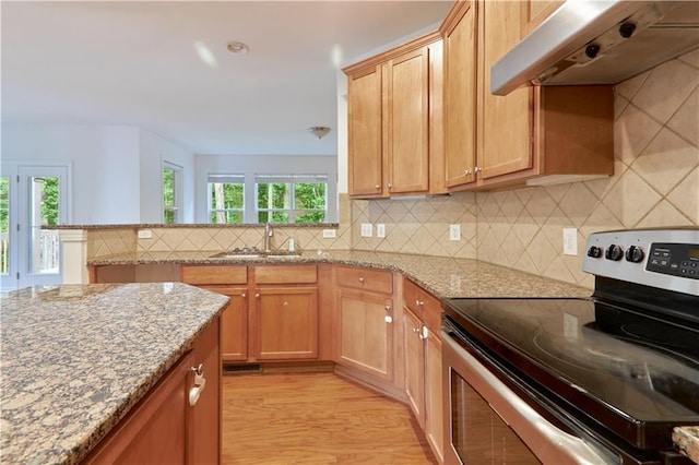 3690 Dalwood Dr, Suwanee, GA 30024 - kitchen with light stone counters, backsplash, stainless steel electric stove, light wood-type flooring, and wall chimney exhaust hood