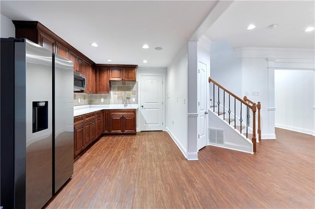 3690 Dalwood Dr, Suwanee, GA 30024 - kitchen with decorative backsplash, stainless steel appliances, and light hardwood / wood-style floors