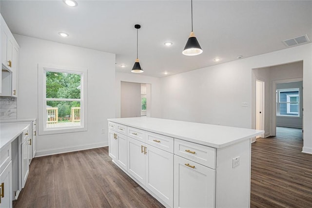 kitchen featuring white cabinets, dark wood-type flooring, visible vents, and light countertops