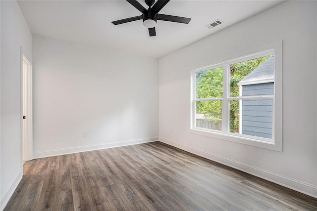unfurnished room with wood finished floors, visible vents, baseboards, and ceiling fan