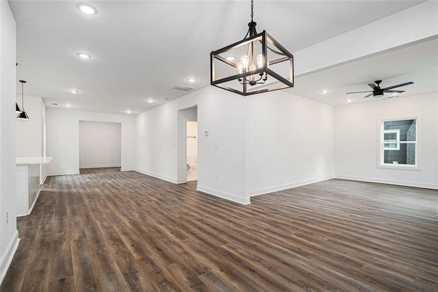 unfurnished living room featuring recessed lighting, visible vents, dark wood-type flooring, baseboards, and ceiling fan with notable chandelier