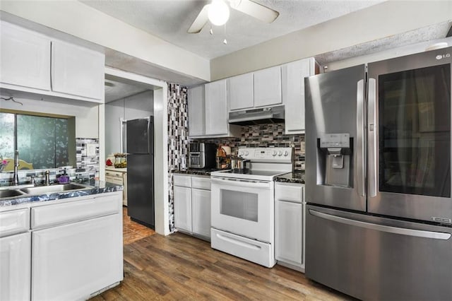 kitchen featuring white cabinetry, stainless steel fridge, black refrigerator, and white electric range