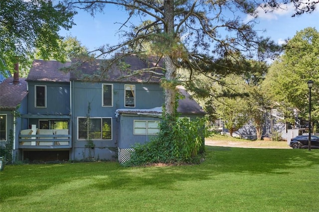 rear view of property with a yard