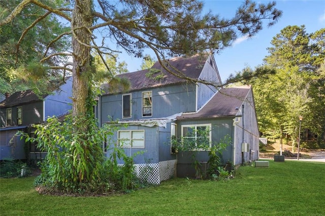 view of side of property with a lawn