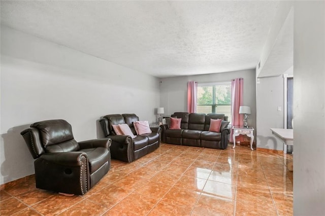 living room featuring tile patterned flooring and a textured ceiling