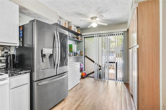 kitchen with decorative backsplash, stainless steel fridge, a textured ceiling, ceiling fan, and white cabinets