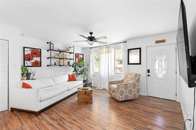 living room with hardwood / wood-style flooring and ceiling fan