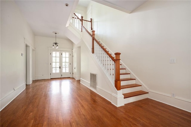 foyer entrance with french doors and dark hardwood / wood-style floors