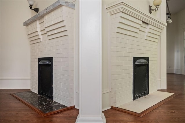 details with a brick fireplace and hardwood / wood-style flooring